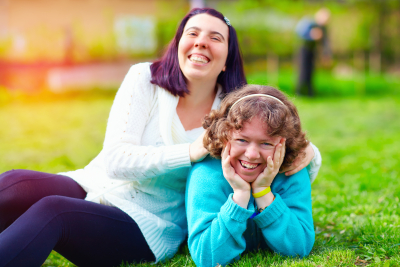 two women at the park smiling